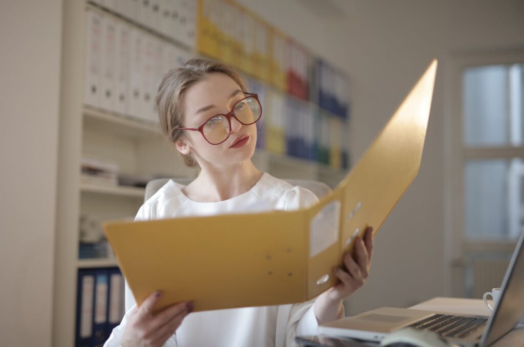 receptionist reviewing files office staff intensely reviewing files